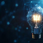 A digital lightbulb made up of interconnected lines and points glows brightly against a dark background with a network of blue, glowing connections, symbolizing Coyyn.com Innovation and interconnected ideas in technology. | COYYN