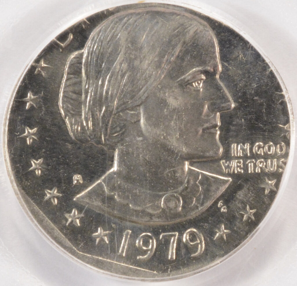 Close-up of a 1979 Susan B. Anthony dollar coin from Coyyn.com Rare Coins. It features a profile portrait of Susan B. Anthony facing right, surrounded by 13 stars, with "LIBERTY" at the top and "IN GOD WE TRUST" to the right. | COYYN