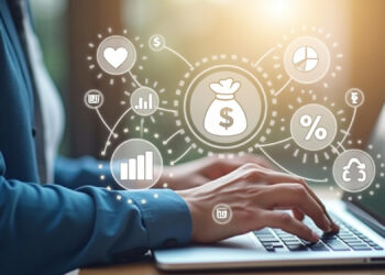 Amidst floating icons like a money bag, percentage sign, graphs, heart, and dollar symbol, a person types on their laptop. This scene captures Coyyn.com's innovation in financial services through cutting-edge data analytics and fintech advancements. | Coyyn.com Innovation in Financial Services