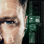 Close-up of a person's face with digital overlays, showcasing cutting-edge technology trends in biometric scanning. The interface includes holographic data like charts and graphs, suggesting a futuristic or security-related theme. The eye is prominently focused, embodying innovation at its core. | COYYN