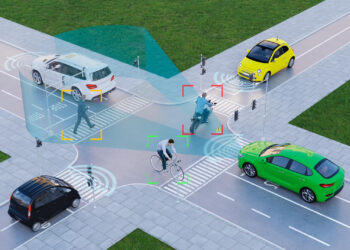 A digitally rendered intersection with cars, a cyclist, and a pedestrian, showing sensor and detection technology highlighting their positions for autonomous vehicle navigation aimed at reducing accidents. | COYYN