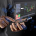 A person uses a smartphone with a futuristic, transparent screen displaying a financial chart, trading options, and digital data, surrounded by blue glowing particles. | COYYN