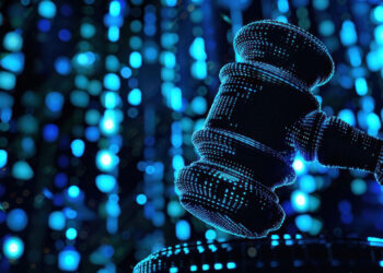 A digital illustration of a judge’s gavel composed of glowing blue dots, with a vibrant background of blue light and bokeh effects, symbolizing technology in law or digital justice. | COYYN