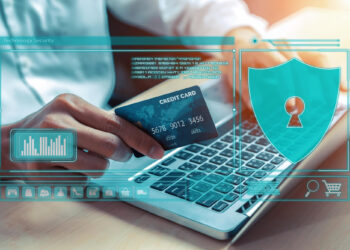 A person holding a credit card while using a laptop, with digital security icons and graphics overlaid, representing online payment and cybersecurity. | COYYN